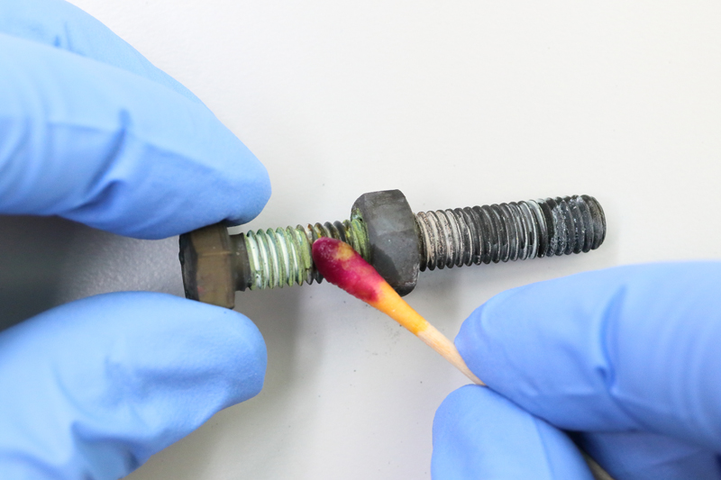 Example of a stainless steel 304 (A2) bolt and nut with anti-seize paste after heat treatment. The formed greenish chromate is clearly visible. The TK11™ Chromium-6 Detection Test swab clearly turns red/purple, indicating that chromium-6 is present.